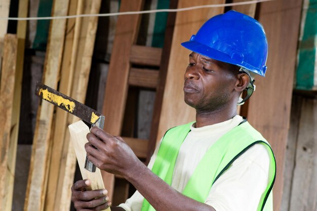 A carpenter taking measurements