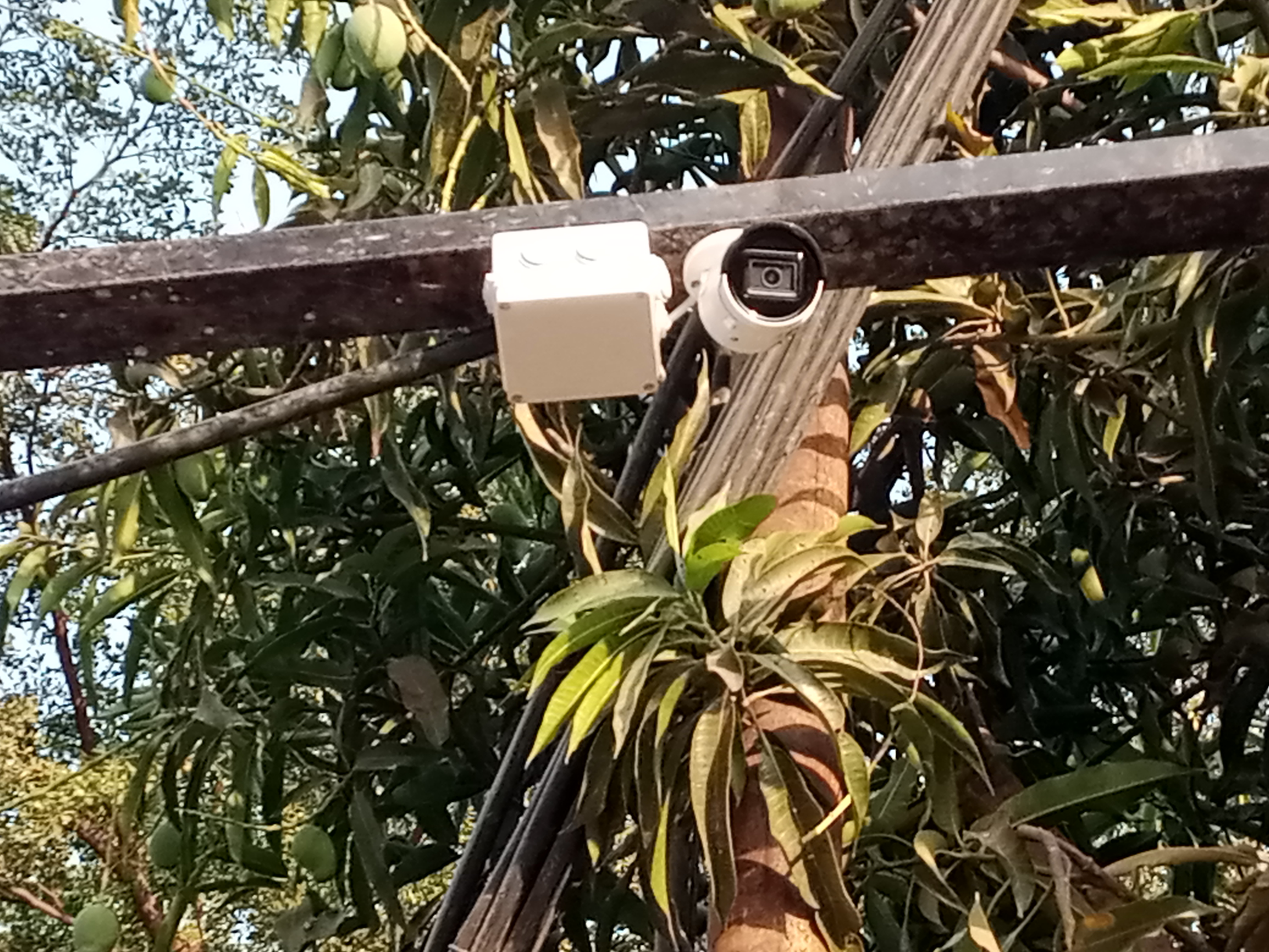 A bullet camera mounted on metal