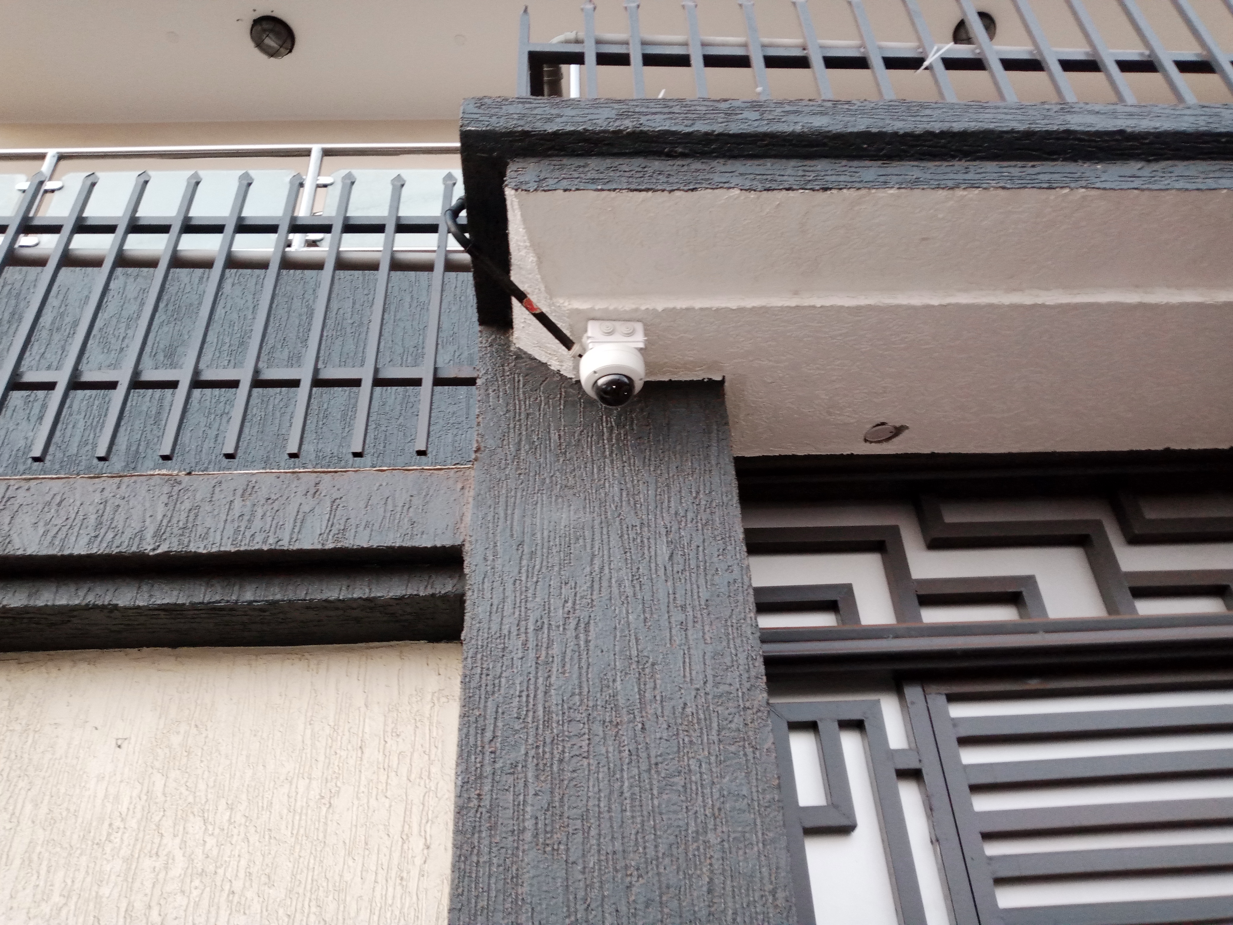 A dome CCTV camera mounted outdoor on adapter box