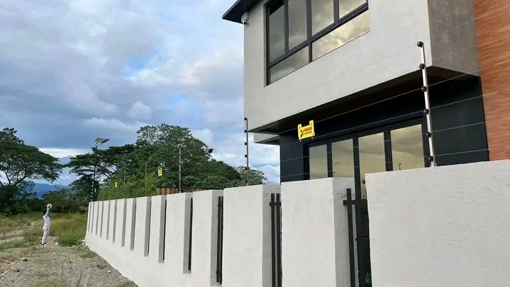 Electric fence extended on a milky colored wall fence