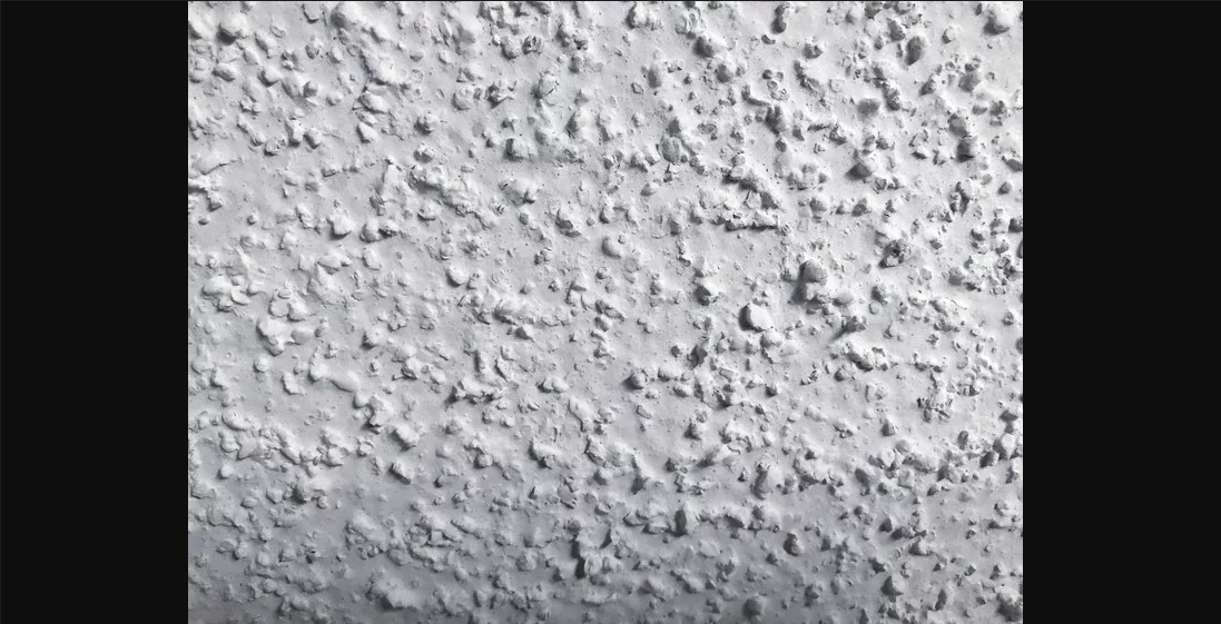 A popcorn wall texture in white color