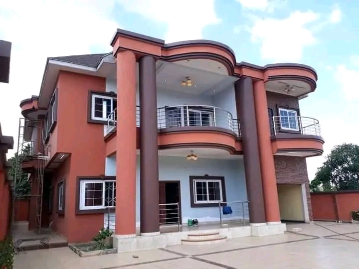 A completed residential house painting project with orange,
             white and brown paints