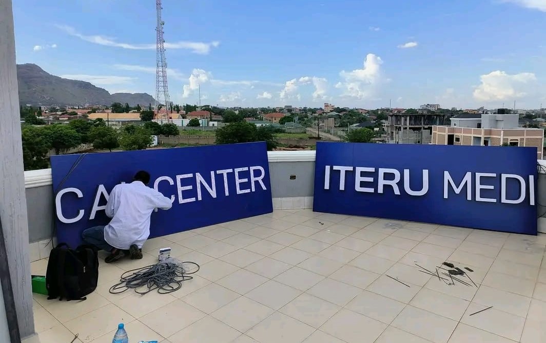 A man designing a 3D illuminated advertising signage in Juba, South Sudan
