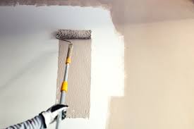 A paint roller painting a wall